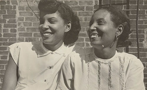 Two Puerto Rican women smiling, black and white photo