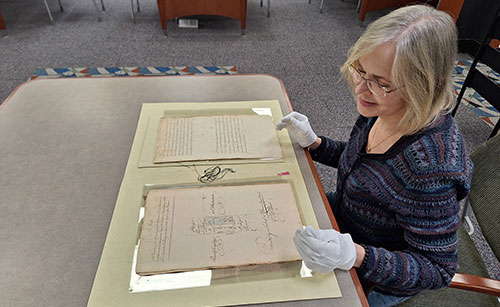 Archivist handling historic materials