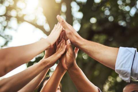 Group of hands coming together